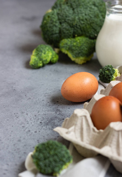 Eggs, milk and broccoli. Ingredients for making omelette or frittata. - Photo, Image