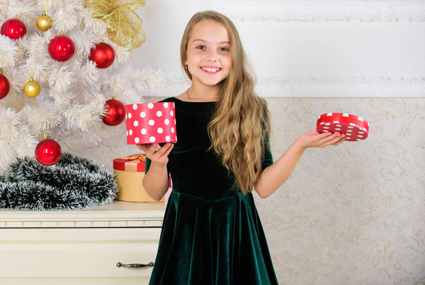 Time to open christmas gifts. Opening christmas presents. Dreams come true. Surprise concept. Kid girl near christmas tree hold gift box. Child celebrate christmas at home. Favorite day of the year - Fotó, kép