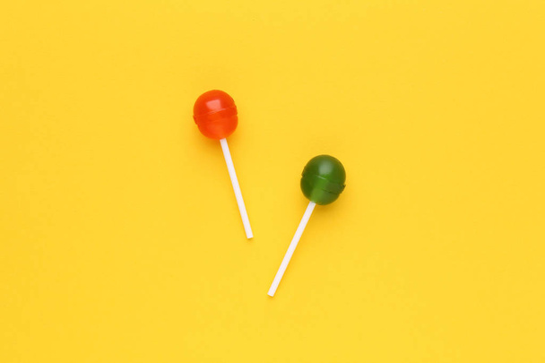 Sweet lollipops on yellow background - Photo, Image