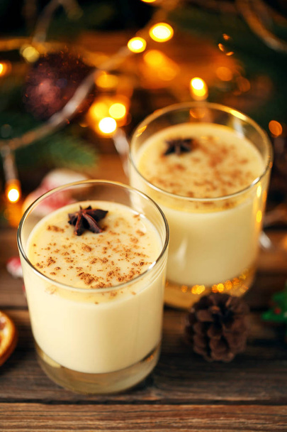 Eggnog in glasses with star anise on wooden table - Photo, image