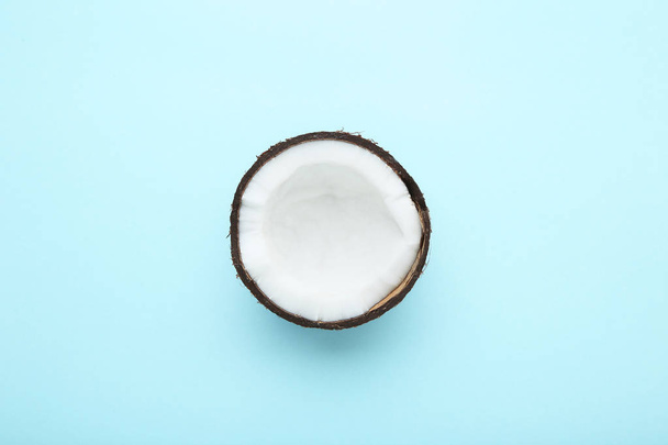 Piece of coconut on blue background - Фото, изображение