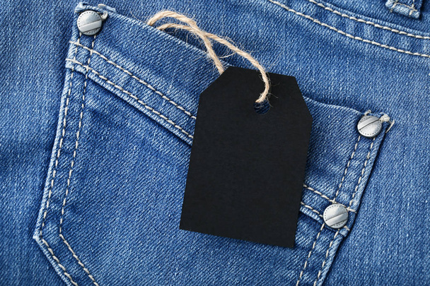 Black sale tag with jeans - Foto, afbeelding