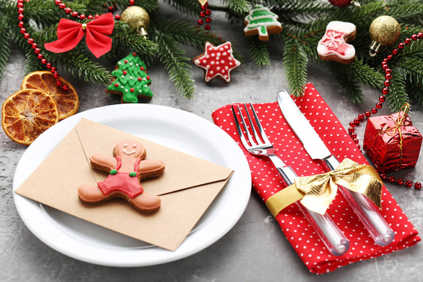 Kitchen cutlery with plate and gingerbread cookies on wooden table - Фото, изображение
