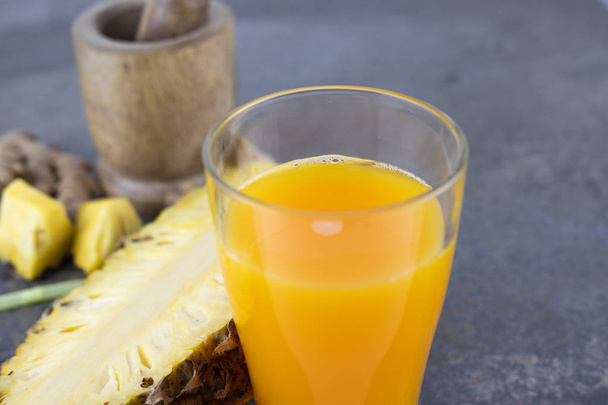 still life photo of pineapple juice, pineapple smoothie in glass on concrete background. - Valokuva, kuva