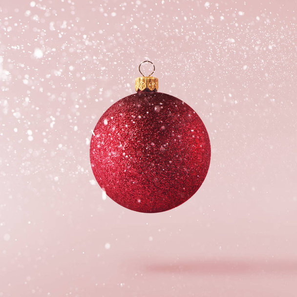 Рождественская идея. Творческая рождественская концепция выполнена путем падения в воздухе блеска на розовом фоне. Минимальная концепция
 - Фото, изображение