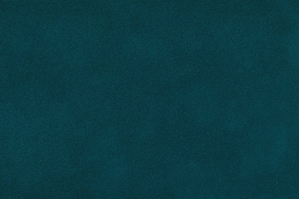 Dark green matte background of suede fabric, closeup. Velvet texture of seamless navy blue leather. Felt materisl macro. - Foto, Imagem