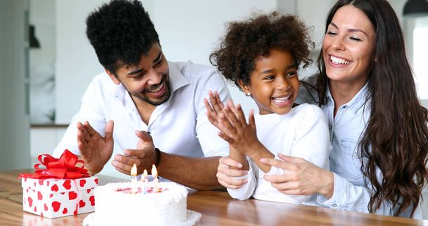 Happy family celebrating a birthday together at table at home in the kitchen - Foto, Imagem