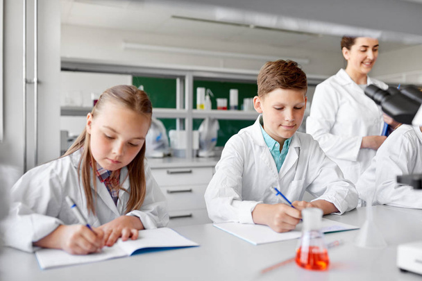 teacher and students studying chemistry at school - Foto, Imagen