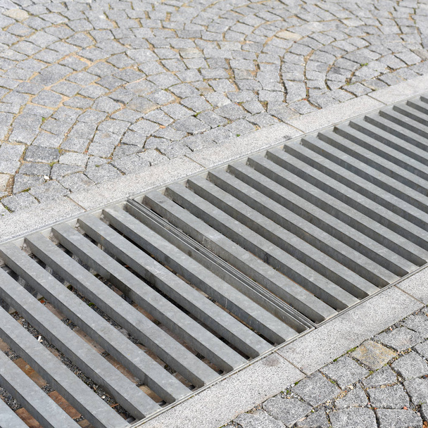 Cobblestone pavement with a drain. - Photo, Image