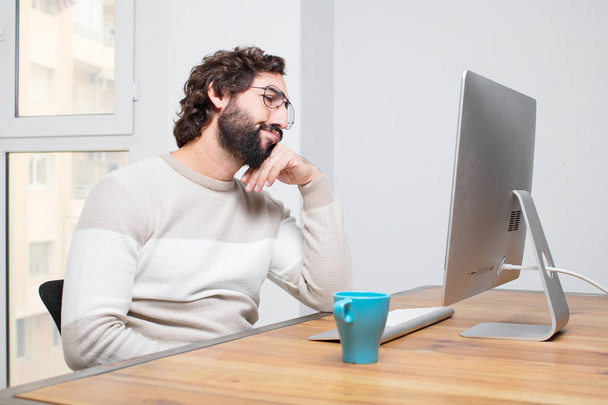 young bearded crazy freelancer working with his computer - 写真・画像
