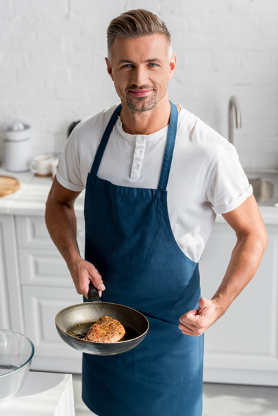 adult man showing thumbs up with steak on pan  - Foto, Bild