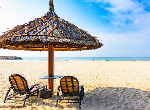 Group deck chairs under an umbrella on a sandy beach sea tropical sunny day - Fotoğraf, Görsel