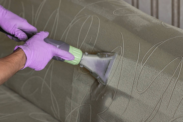 Closeup of upholstered Sofa chemical cleaning with professional extraction method. - Zdjęcie, obraz