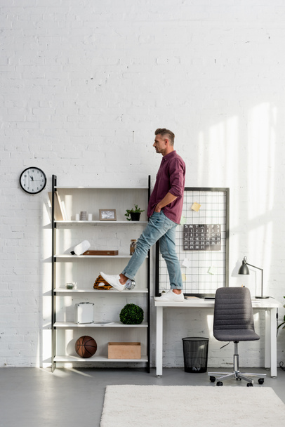 man stepping from desk at home office - Foto, imagen
