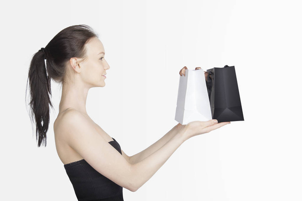 Black Friday Sales Concept with Young Woman and White Black Bags - Valokuva, kuva