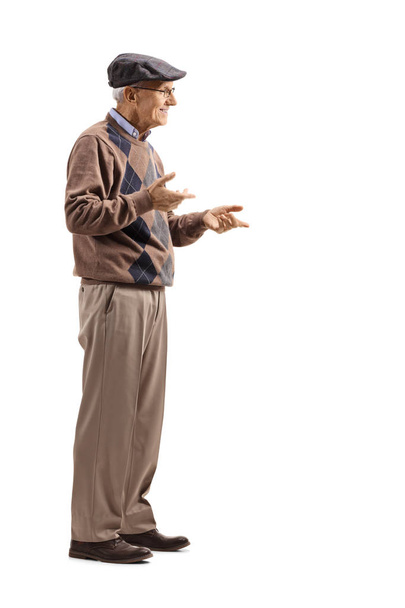 Full length shot of a senior man standing alone and gesticulating conversation isolated on white background - Foto, Imagen
