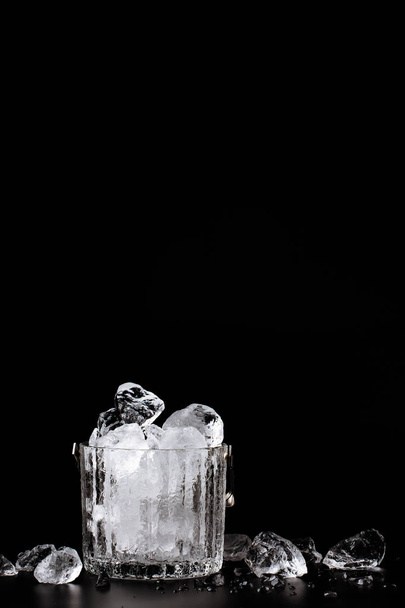 crystal bucket with ice on a dark background - 写真・画像