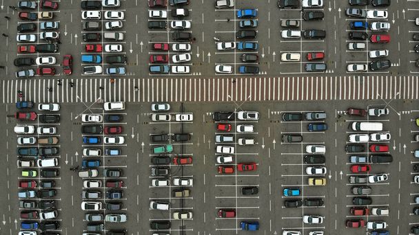 Aerial. Parking lots with a lot of cars and pedestrian crosswalk between them. Bird eye view above.  - Photo, Image