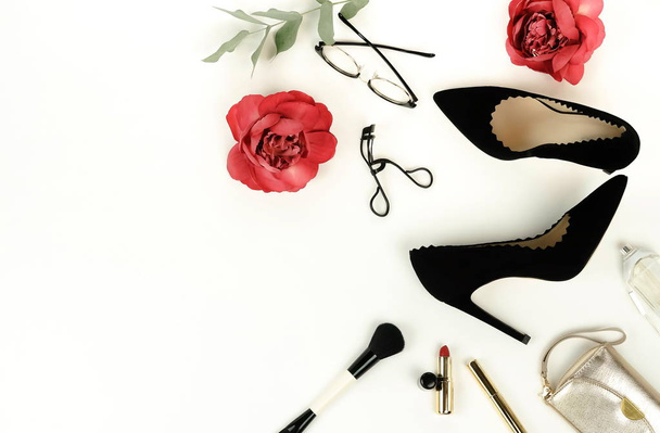 Flat lay, top view female black high heels shoes, accessories and make up cosmetics. bag, glasses, lipstick, mascara, on a white background.  Copy space. - Foto, imagen