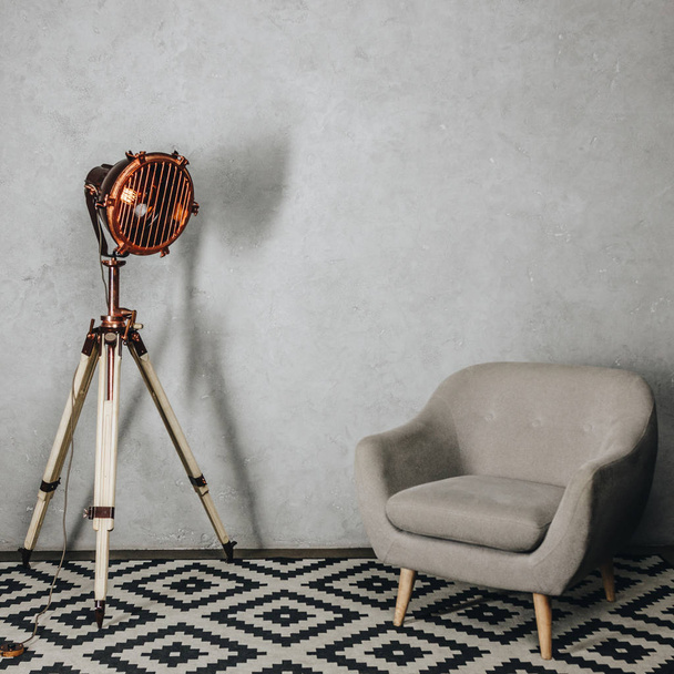 Minimalistic interior with grey arm chair and vintage lamp - Foto, Imagem