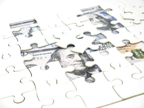 Missing jigsaw puzzle pieces on 100 Dollar money background, Key for Business solution success concept. - Φωτογραφία, εικόνα