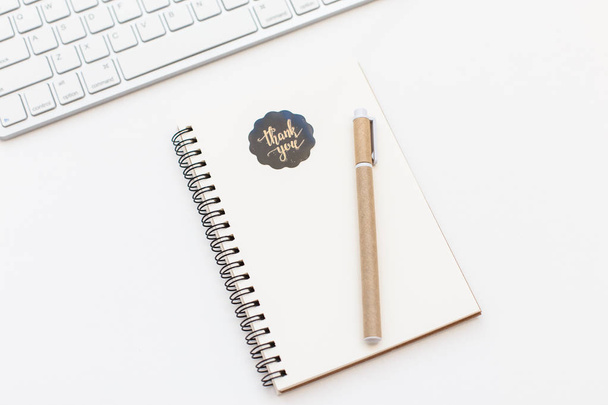 Blank notebook with thank you sticker, pen and keyboard on white background. Notepad space for text input - Foto, imagen