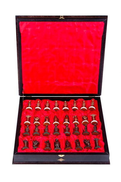 Box with chess pieces on white background - Photo, Image