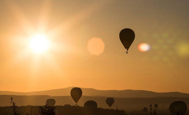 Hot air balloons silhouette in beautiful sunset. Freedom  and travel concept. - Fotó, kép