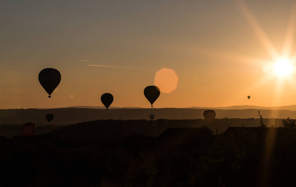 Hot air balloons silhouette in beautiful sunset. Freedom  and travel concept. - Fotó, kép