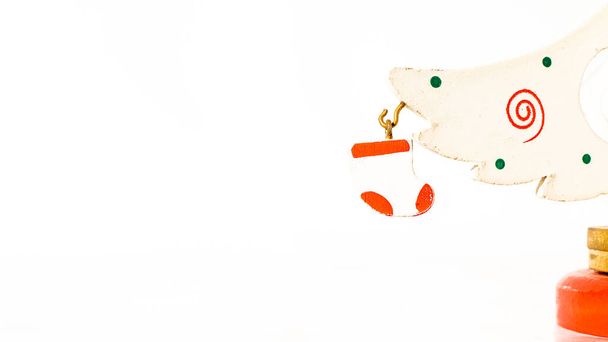 Різдвяний білий квиток прикрашений дерев'яною білою рукавичкою, що висить на гілці дерев'яної іграшкової ялинки
 - Фото, зображення