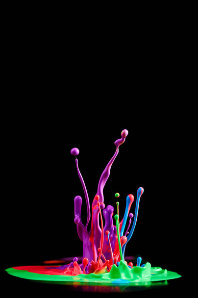 Dancing colored paint. Abstract sculpture dye. Splash of ink on a black background - Photo, Image