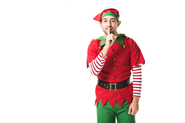 man in christmas elf costume showing hush silence sign and looking at camera isolated on white - Photo, Image