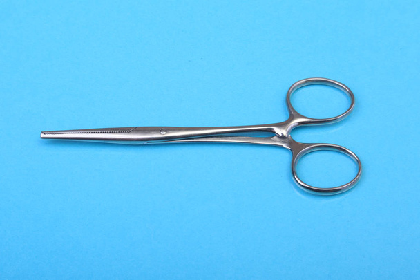 Close Up Surgical instruments and tools on blue mirror background. Selective focus. - Foto, Bild