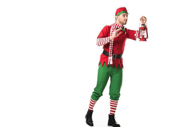 赤い提灯と見て白で隔離距離を保持しているクリスマスのエルフの衣装の男 - 写真・画像