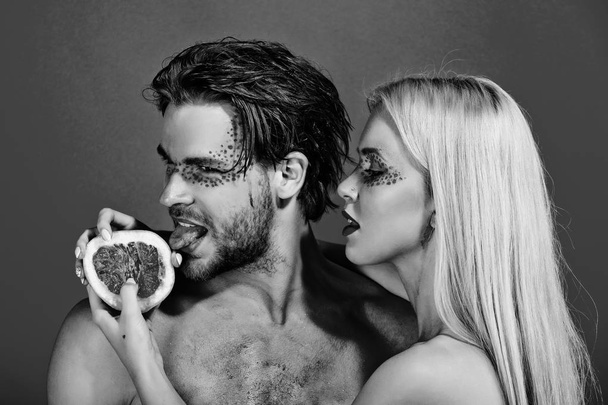 couple of woman and man with makeup hold grapefruit - Foto, immagini