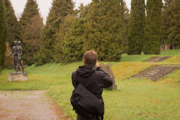 male tourist make photo in the beautiful autumn park - Фото, изображение