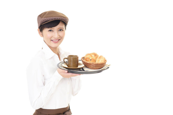 Young waitress serving meals at restaurant - Photo, Image