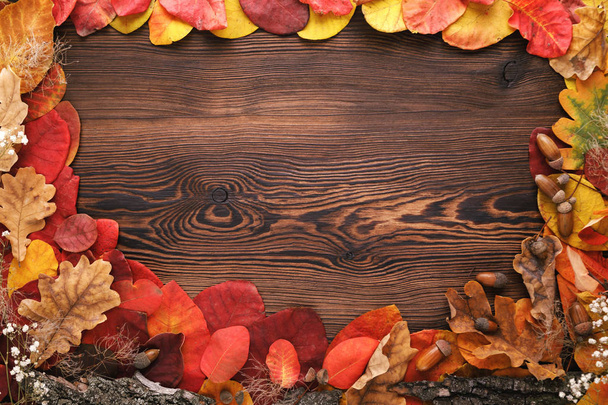 hojas de otoño, bellotas y flores sobre fondo de madera
 - Foto, Imagen