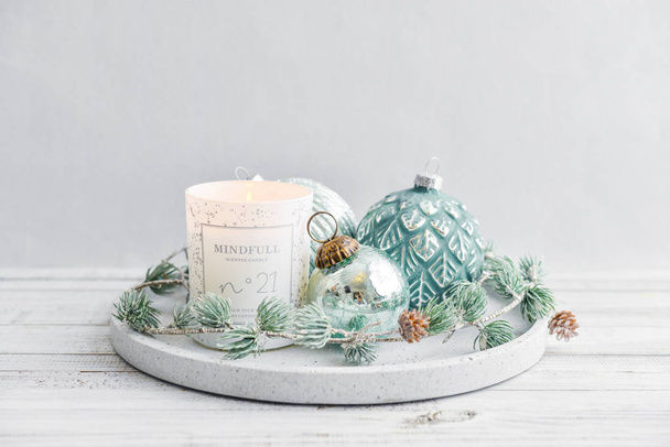 Tray with christmas decorations and candle on white wooden background closeup - Zdjęcie, obraz