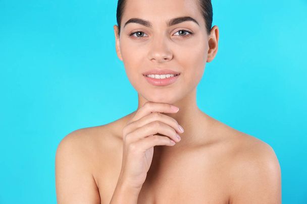 Portrait of beautiful young woman on color background. Lips contouring, skin care and cosmetic surgery concept - Φωτογραφία, εικόνα