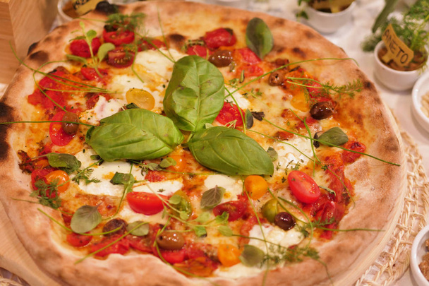 Composition of a typical Italian pizza with ingredients typical of Italian gastronomy. Concept of: pizza, Italian tradition, Naples, Mediterranean flavors - Valokuva, kuva