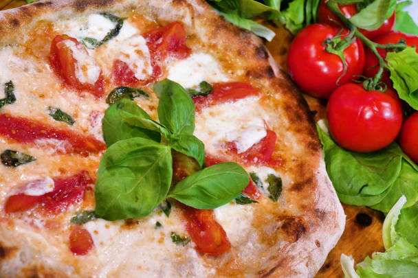 Composition of a typical Italian pizza with ingredients typical of Italian gastronomy. Concept of: pizza, Italian tradition, Naples, Mediterranean flavors - Fotó, kép