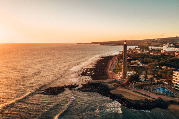 Aerial lighthouse view in Meloneras area on Gran Canaria island during magical sunset. - Foto, Imagem