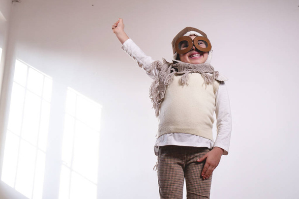 playful adorable little girl dressed as pilot  - Fotografie, Obrázek