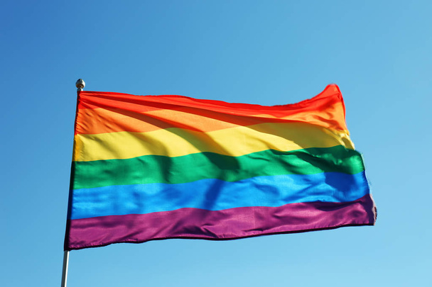 Rainbow LGBT flag fluttering on blue sky background. Gay rights movement - Fotografie, Obrázek