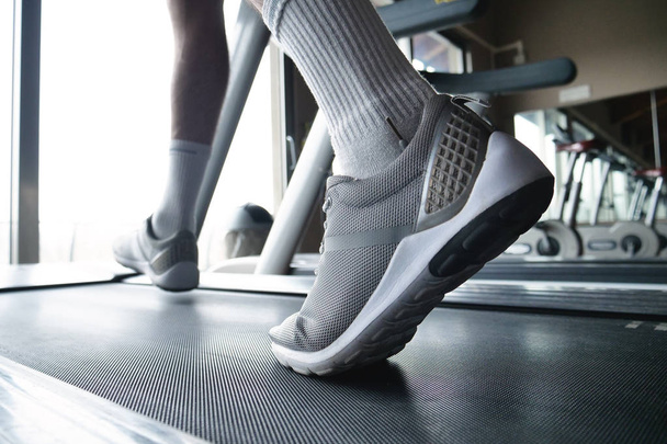 partial view of man running on treadmill, sport shoes  - Zdjęcie, obraz