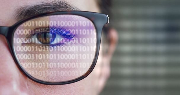 partial view of woman wearing glasses, eye and futuristic interface hologram on glass surface  - 写真・画像