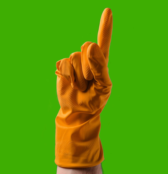 Рука з жовтими гумовими рукавичками вказує вгору з індексним пальцем, синій фон
 - Фото, зображення