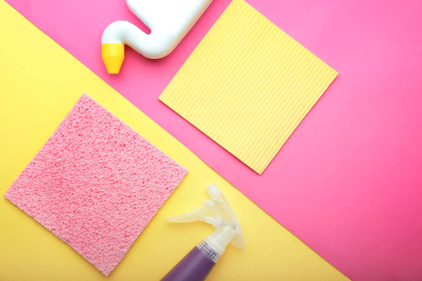Flat lay composition with cleaning supplies on color background - Valokuva, kuva