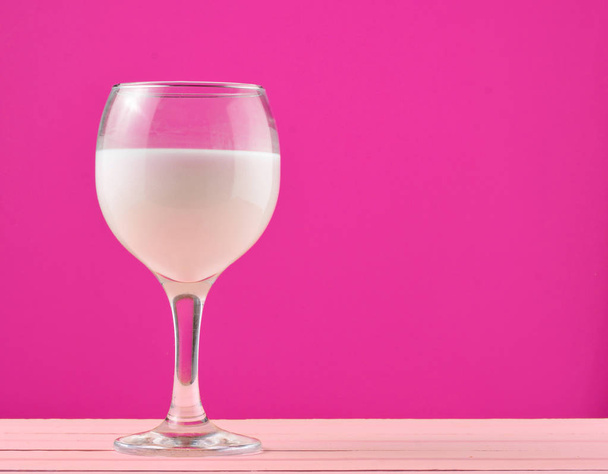 A glass of fresh natural milk on a yellow background. Copy space - Fotografie, Obrázek